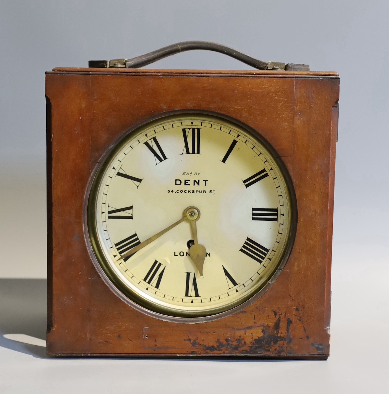 A 19th century mahogany cased circular lacquered brass travelling timepiece marked Dent London, case width 28 cms.